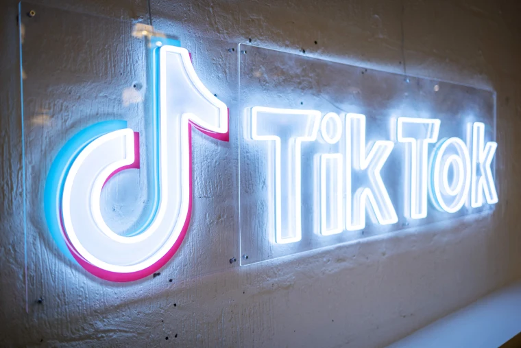 neon sign that says tiktok